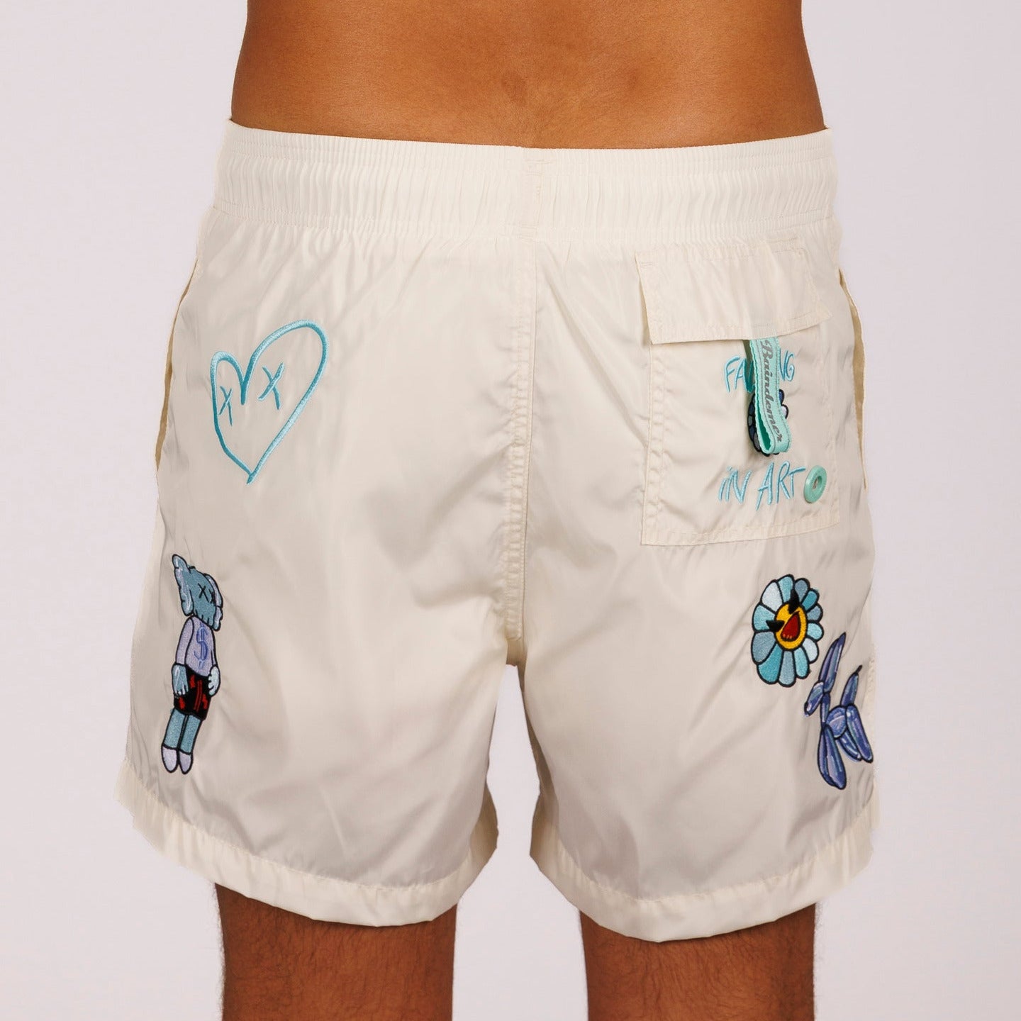 Off-white swim shorts back view with illustrated graphic