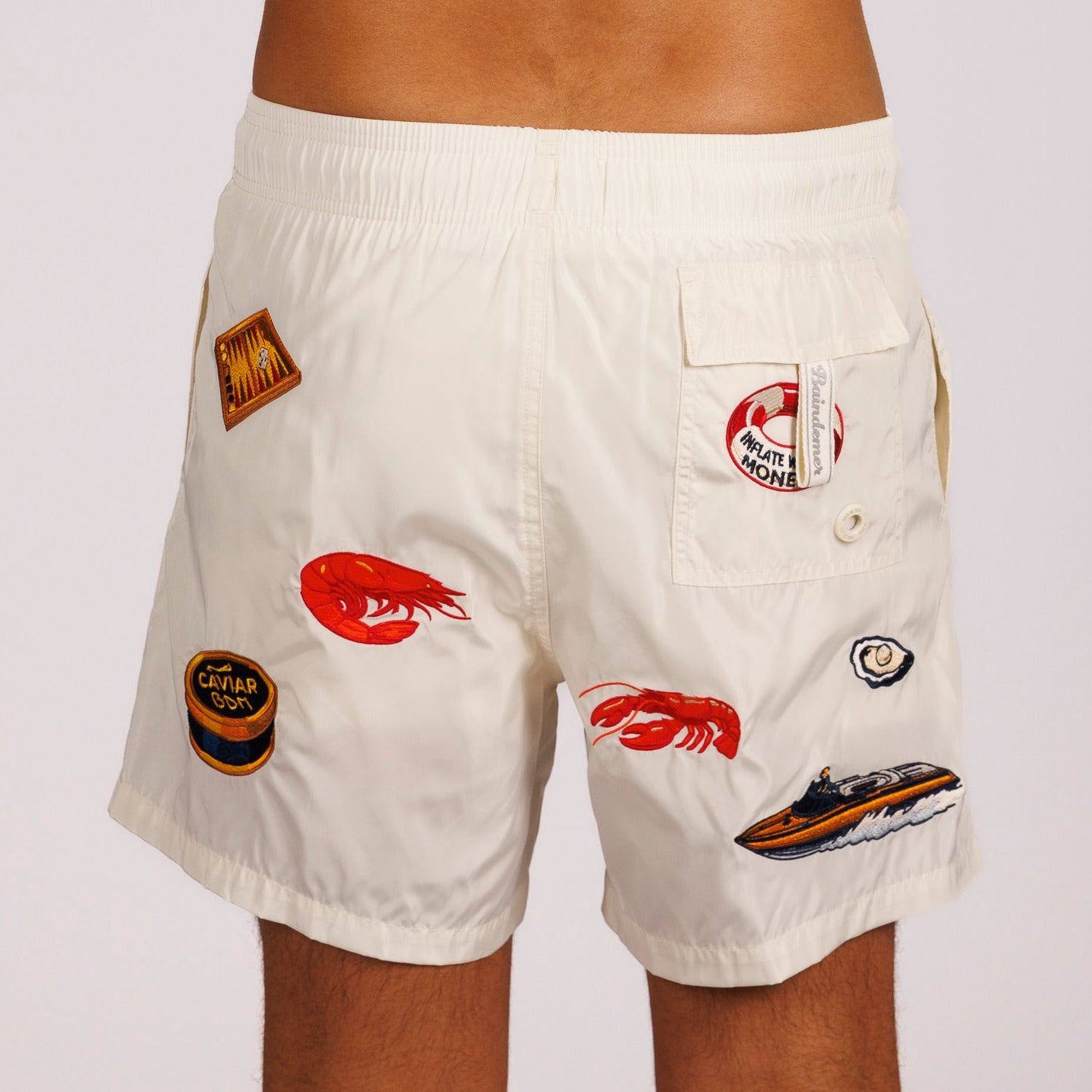 Off-white swim shorts back view with illustrated graphic
