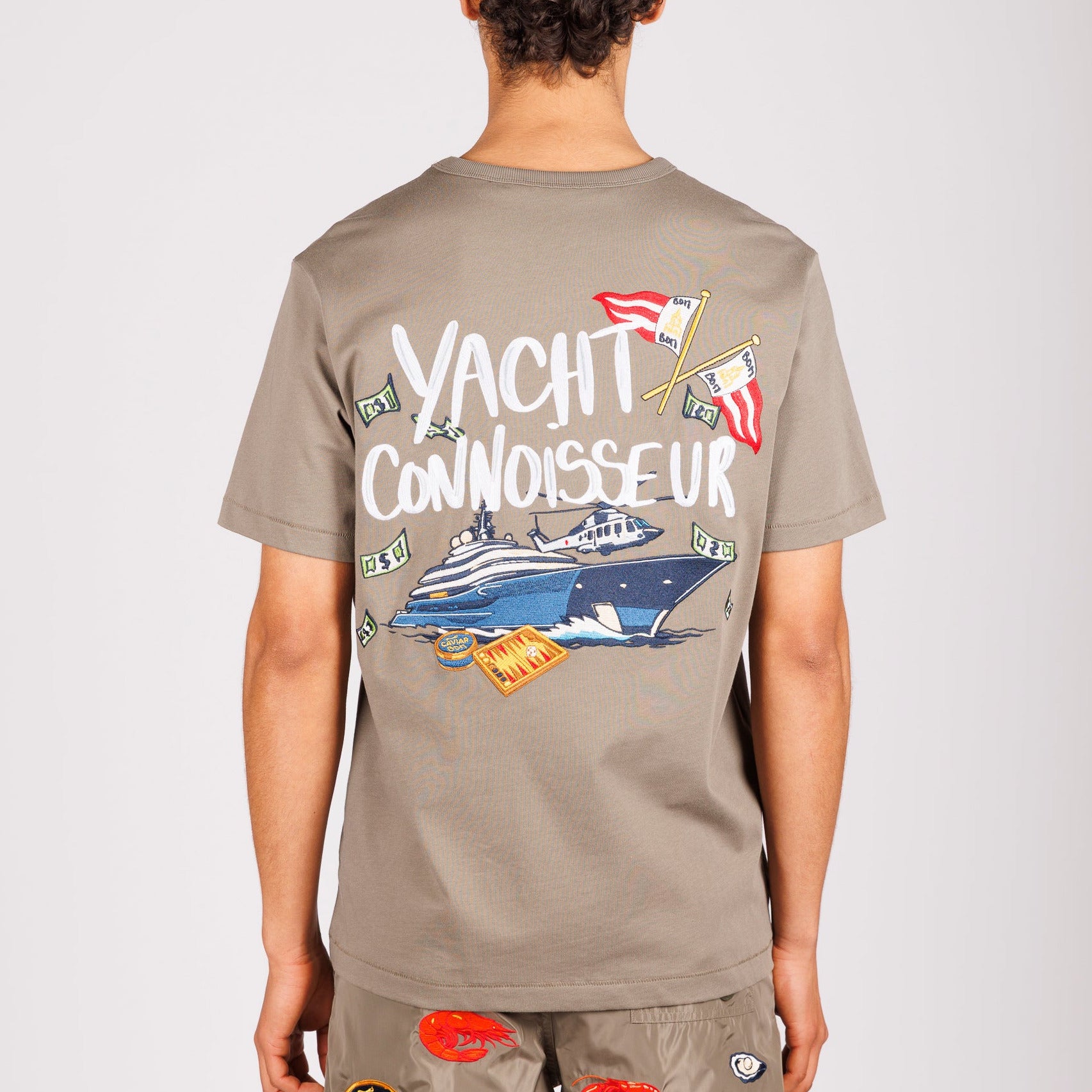 Khaki T-shirt back view with illustrated graphic and “Yacht connoisseur” text