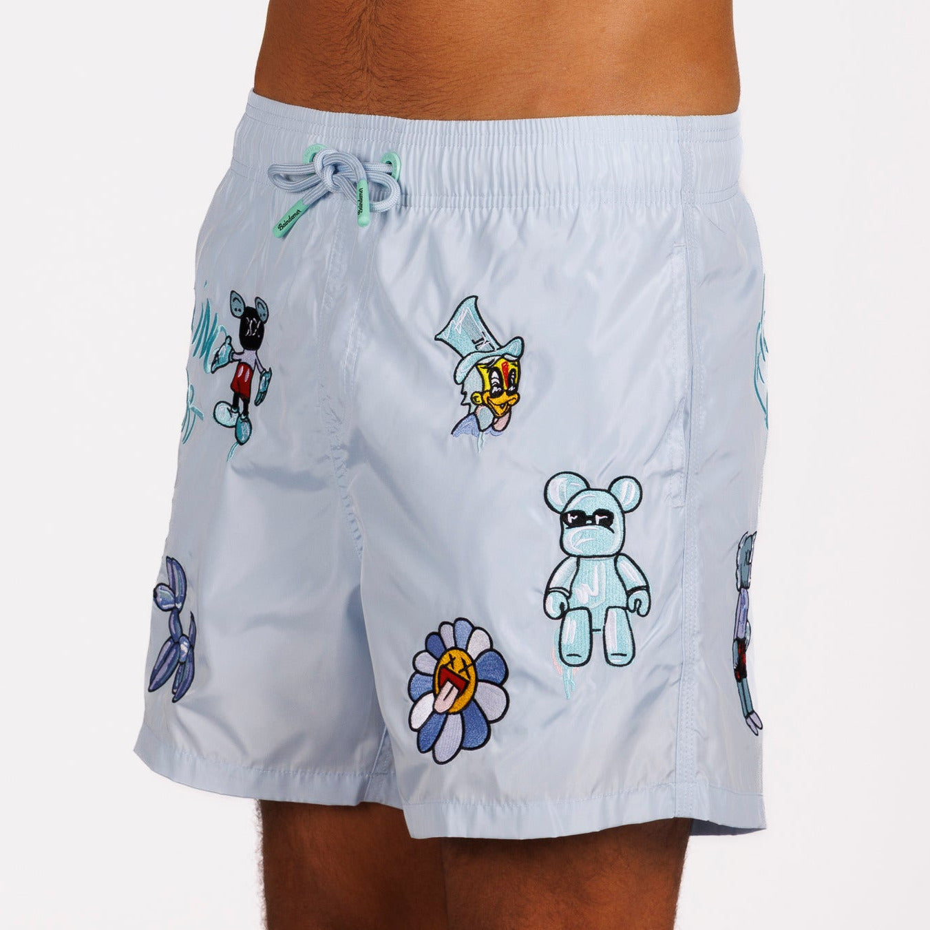 Light blue swim shorts side view with illustrated graphic