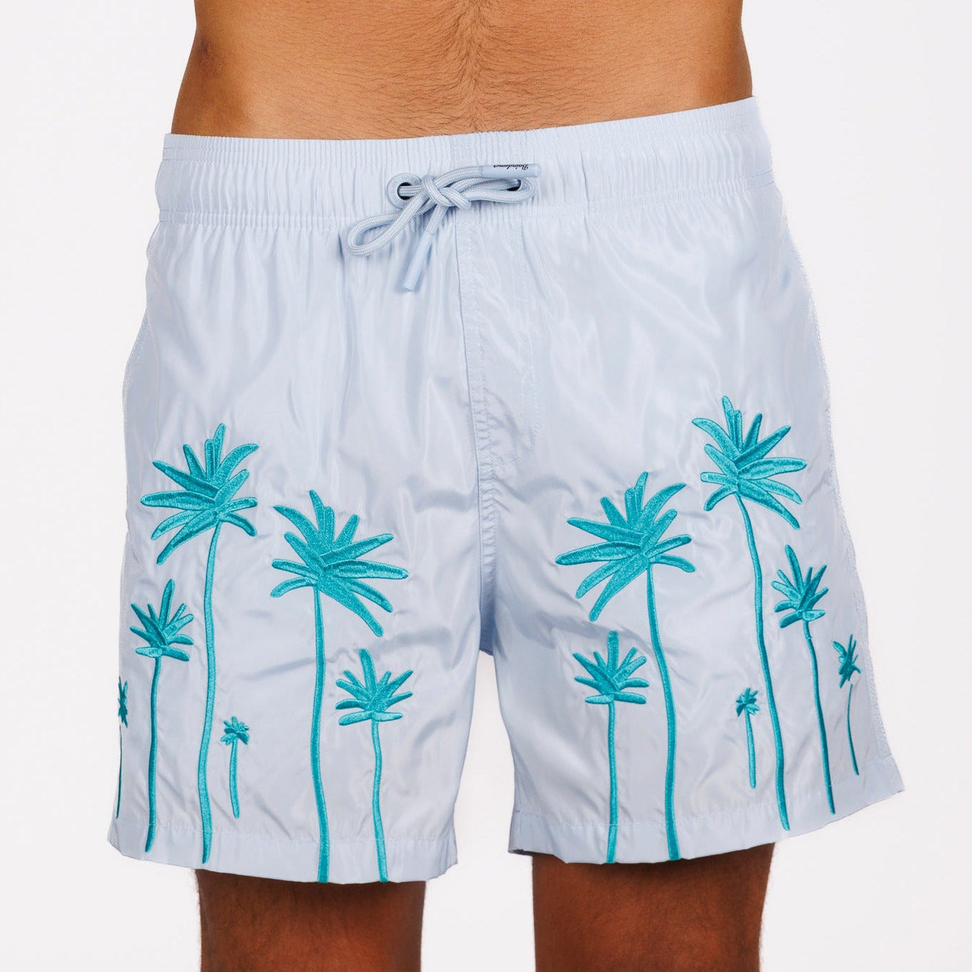 Ligth blue swim shorts front view with illustrated graphic