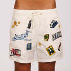 Off-white swim shorts front view with illustrated graphic and “Taxes optimized” text