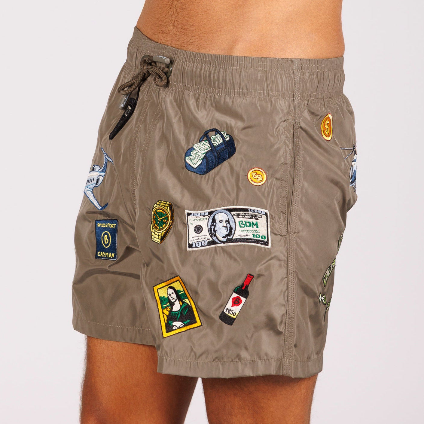Khaki swim shorts side view with illustrated graphic