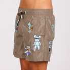 Khaki swim shorts side view with illustrated graphic