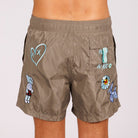 Khaki swim shorts back view with illustrated graphic