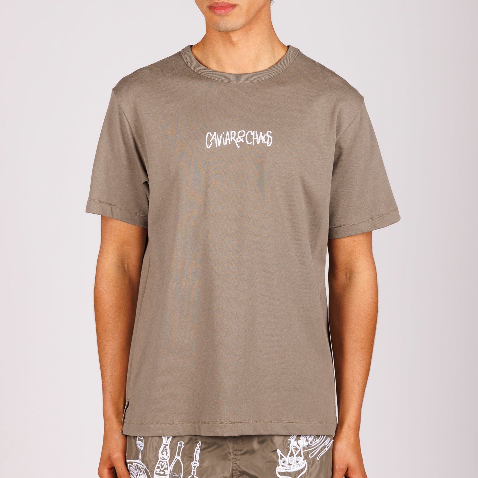 Military green T-shirt front view with “Caviar&Chaos” text