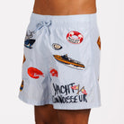 Light blue swim shorts side view with illustrated graphic and “Yacht connoisseur” text