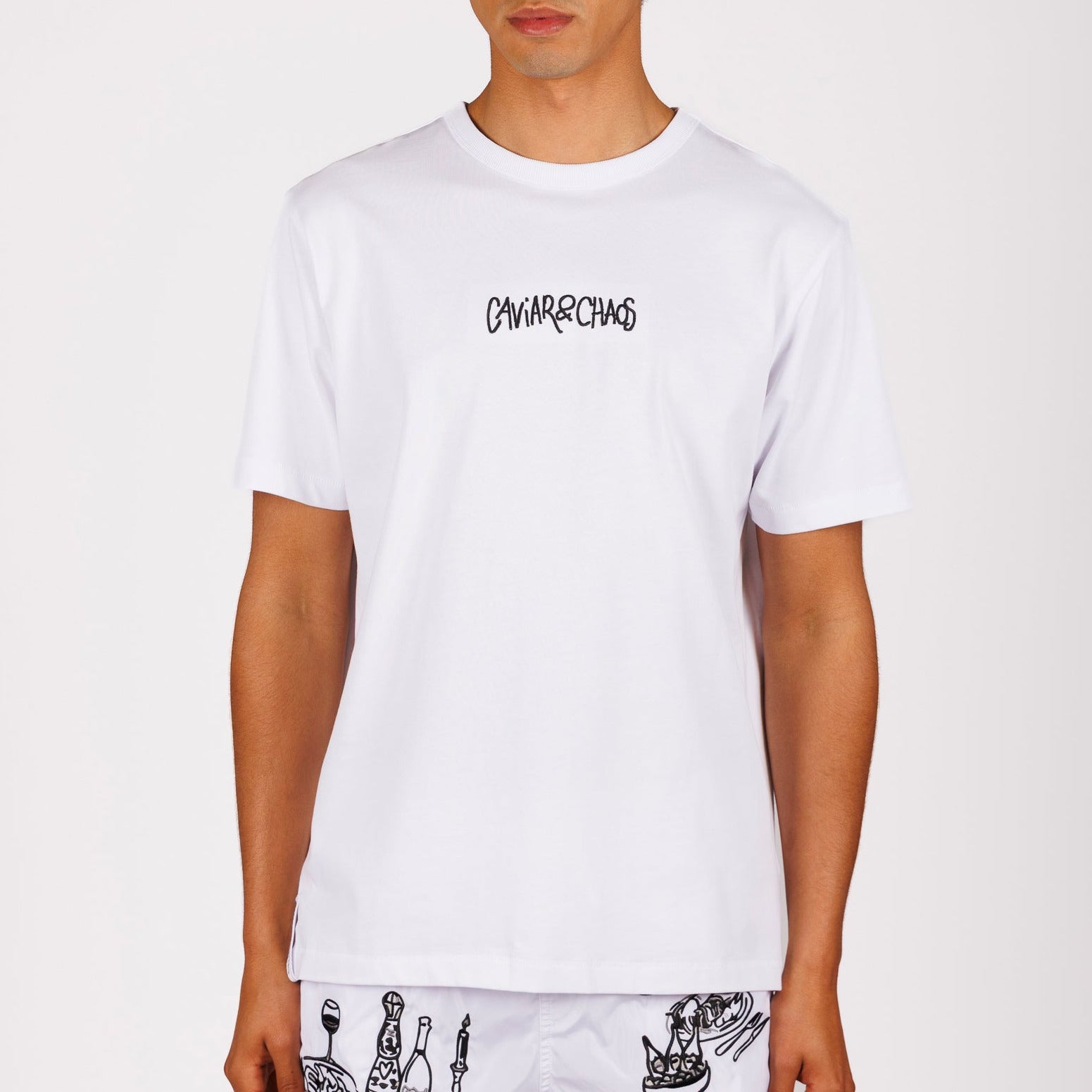 White T-shirt front view with “Caviar&Chaos” text