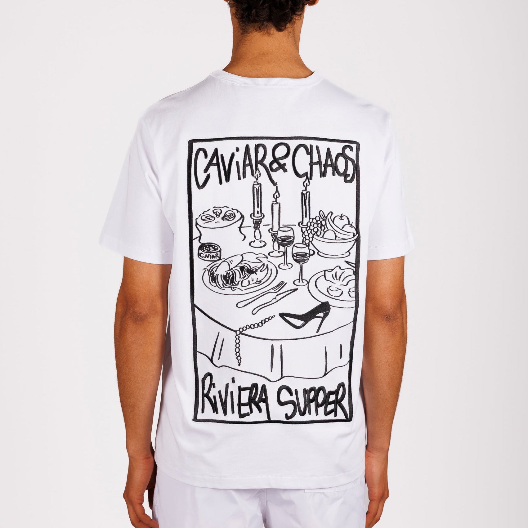 White T-shirt back view with illustrated graphic and “Caviar&Chaos Riviera Supper” text