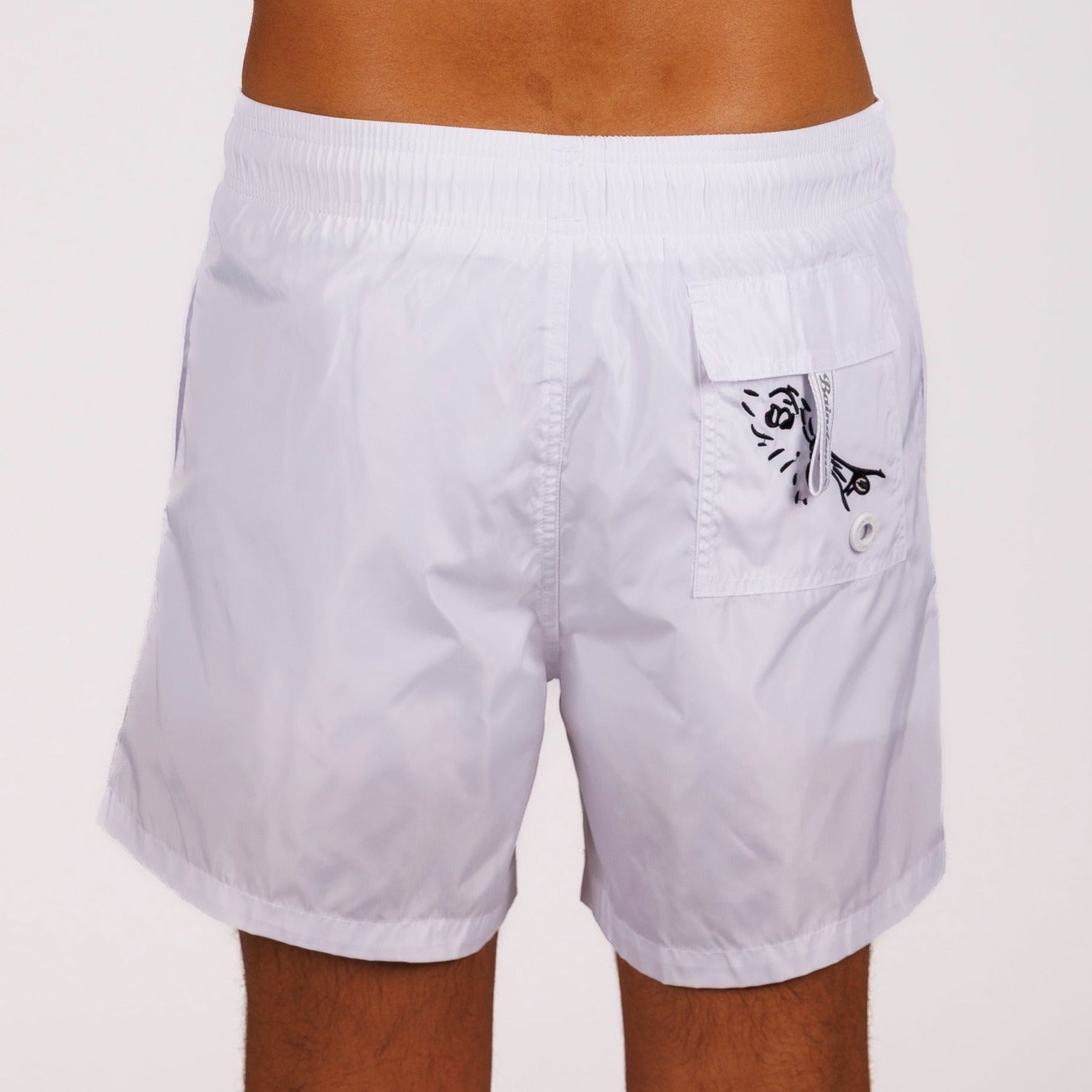 White swim shorts back view with illustrated graphic 
