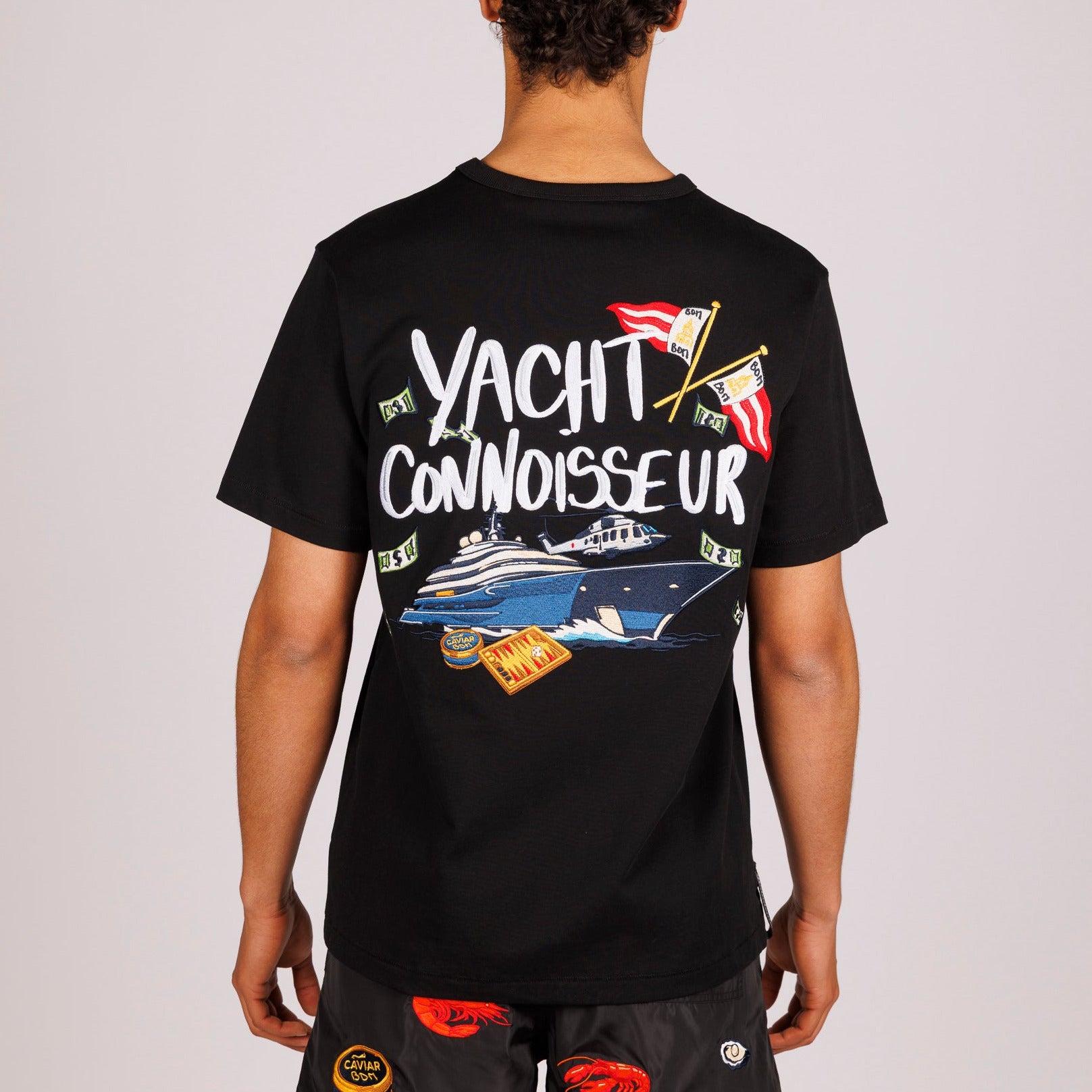 Black T-shirt back view with illustrated graphic and “Yacht connoisseur” text