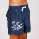 Navy blue swim shorts side view with illustrated graphic and “BDM Sport 18” text